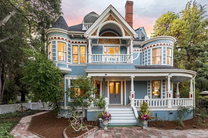 Restored Queen Anne Victorian home with wraparound porch and turret