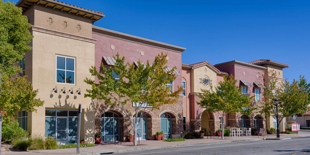 Mediterranean-style mixed-use plaza with stucco facades