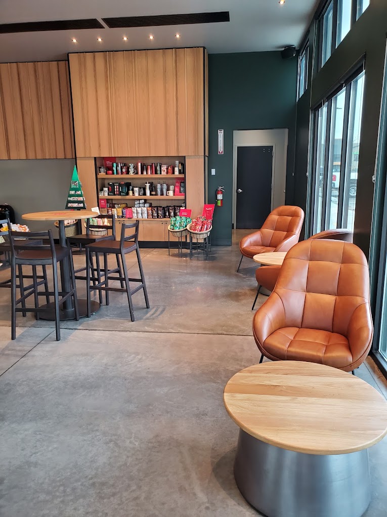 Starbucks cafe interior with leather lounge chairs, bar seating, and product displays