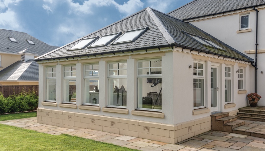 Sunroom addition with slate roof and skylights on a residential home